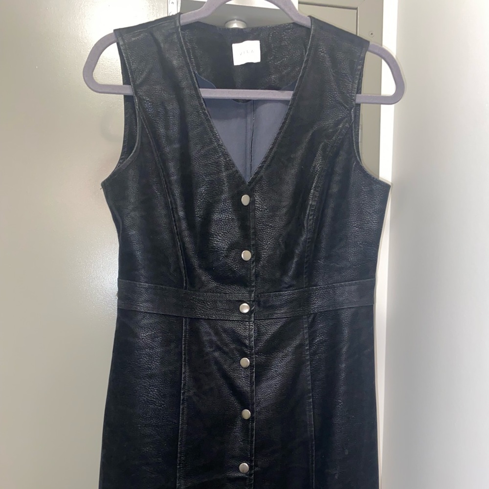 Leather look button up pinafore dress. Perfect for layering during winter time